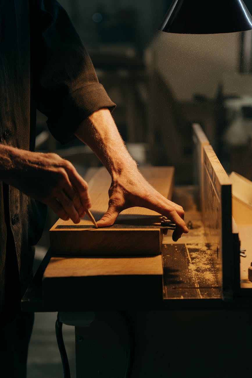 person in black t shirt holding brown wooden table